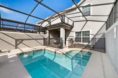 a swimming pool in front of a house at Star Hideaway At Storey Lake By Shine Villas #716 in Kissimmee