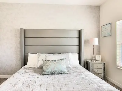 a bedroom with a large bed with a silver headboard at Happy Haven At Storey Lake Resort By Shine Villas #409 in Kissimmee