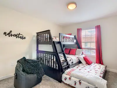 a bedroom with a bed and a bunk bed at Happy Haven At Storey Lake Resort By Shine Villas #409 in Kissimmee
