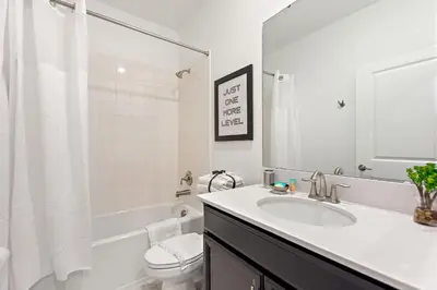 a white bathroom with a sink and a toilet at Stars Align Storey Lake By Shine Villas #406 in Kissimmee
