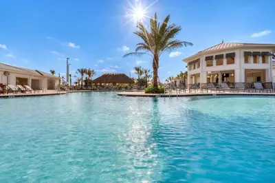 a large swimming pool in front of a building at Decadent Penguin - Storey Lake By Shine Villas #704 in Kissimmee