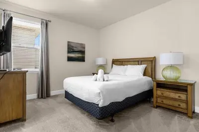 a bedroom with a large bed and a television at 350 Pendant · 350 Villa - 8BD - Private Pool - Game room in Orlando