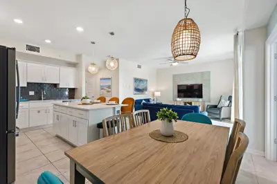a kitchen and living room with a table and a dining room at Serenity Haven, Bliss, Storey Lake By Shine Villas #701 in Kissimmee