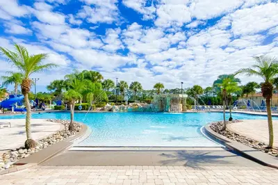 a swimming pool at a resort with palm trees at Mickeys Paradise - a fabulous 4 bed Paradise Palms Resort pool home that's close to Disney in Kissimmee