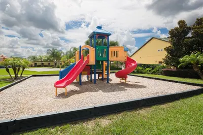 a playground with two slides in a park at Mickeys Paradise - a fabulous 4 bed Paradise Palms Resort pool home that's close to Disney in Kissimmee