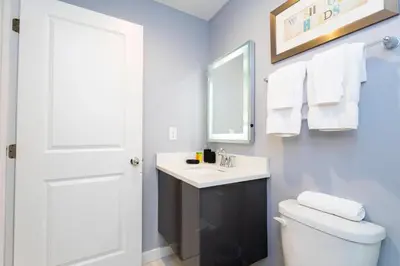 a bathroom with a white toilet and a sink at Amazing Cozy Private Pool - 4404 in Kissimmee