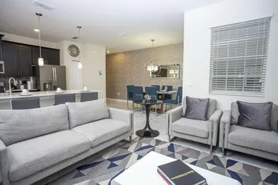 a living room with a couch and chairs and a kitchen at Amazing Lovely Private Pool 4844 in Kissimmee
