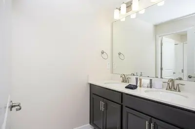 a bathroom with two sinks and a large mirror at Amazing Lovely Private Pool 4844 in Kissimmee