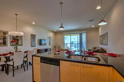 a kitchen with a sink and a dining room at 1523 Cozy Astonishing wPrivate Pool in Orlando