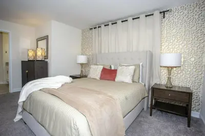 a bedroom with a large bed and two lamps at Astonishing Home Private Pool 4830 in Kissimmee