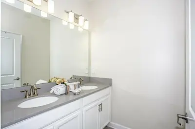 a bathroom with two sinks and a large mirror at Astonishing Home Private Pool 4830 in Kissimmee