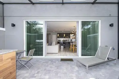 a patio with two chairs and a living room at Modern 4 bedroom Home Private Pool 4451 in Kissimmee