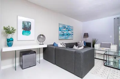 a living room with a couch and a table at 4774 Gorgeous Townhome in Kissimmee