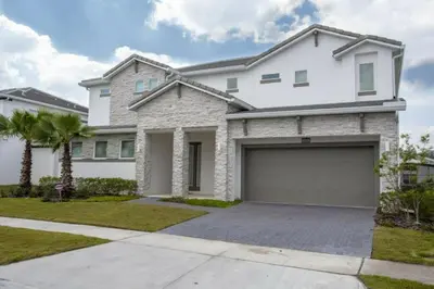a white house with a garage at 2606YA Luxurious En-Suite Single Home Pool in Kissimmee
