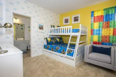 a childs bedroom with a bunk bed and a bathroom at 2606YA Luxurious En-Suite Single Home Pool in Kissimmee