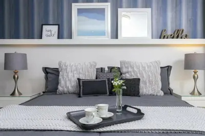 a bed with a tray with two cups on it at Luxurious Home Private Pool 2693 in Kissimmee