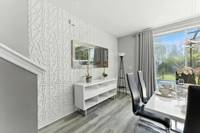 a dining room with a table and a mirror at 4412 Luxurious Townhome Private Pool in Kissimmee