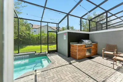 a swimming pool in a house with a glass roof at 4412 Luxurious Townhome Private Pool in Kissimmee