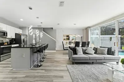 a living room with a couch and a kitchen at 4412 Luxurious Townhome Private Pool in Kissimmee