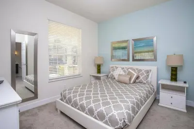 a white bedroom with a bed and a window at 17419 Awesome Modern w Private Pool in Orlando