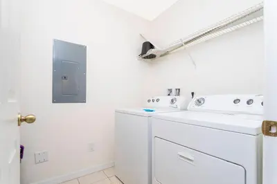 a white laundry room with a washer and dryer at Cozy 3 bedroom home with Private Pool 4564 in Kissimmee