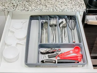a tray filled with utensils on a counter at Your Dream Apartment Stay in Kissimmee