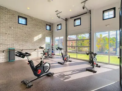 a fitness room with several exercise bikes in it at Your Dream Apartment Stay in Kissimmee