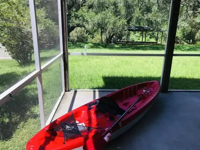 a red kayak sitting inside of a window at Hidden City Riverfront Apt Near Lakes Golf & Disney in Kissimmee
