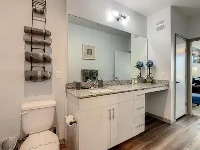 a bathroom with a sink and a toilet and a mirror at Large Apartment, Close To Disney in Kissimmee