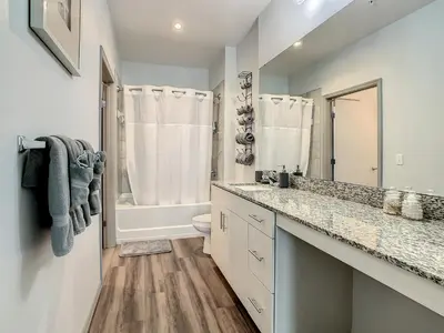 a bathroom with a sink and a toilet and a mirror at Large Apartment, Close To Disney in Kissimmee