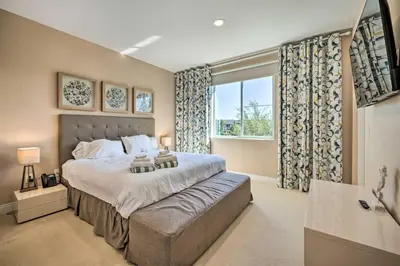 a bedroom with a large bed and a large window at Upscale Townhome Close to Walt Disney World! in Orlando