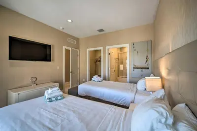 a hotel room with two beds and a flat screen tv at Upscale Townhome Close to Walt Disney World! in Orlando