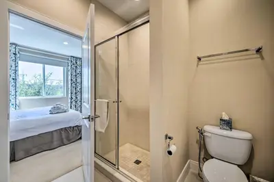 a bathroom with a shower and a toilet with a glass door at Upscale Townhome Close to Walt Disney World! in Orlando