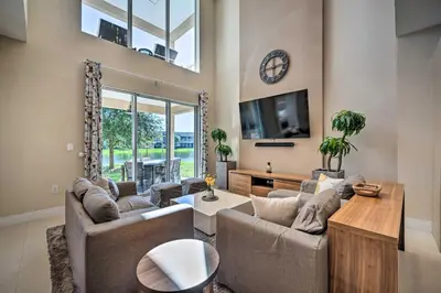 a living room with two couches and a tv at Upscale Townhome Close to Walt Disney World! in Orlando