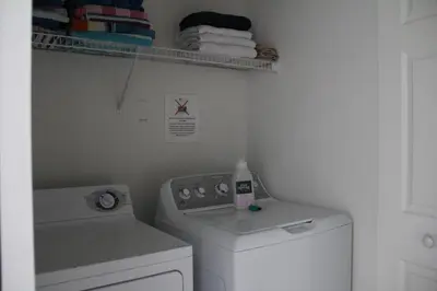 a laundry room with a washing machine and towels at Veteran Owned 3bdr/3 bath Townhouse w/WiFi 3mi to Disney - Fall/Winter Specials in Kissimmee