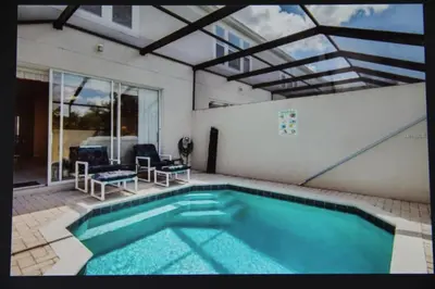 a swimming pool in the middle of a house at Veteran Owned 3bdr/3 bath Townhouse w/WiFi 3mi to Disney - Fall/Winter Specials in Kissimmee