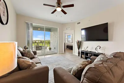a living room with two couches and a flat screen tv at Triple Header Storey Lake By Shine Villas #700 in Kissimmee