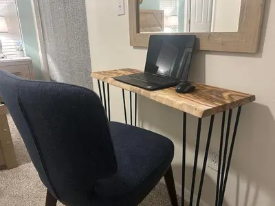 a laptop computer sitting on a desk with a chair at Disney Getaway Villa in Kissimmee