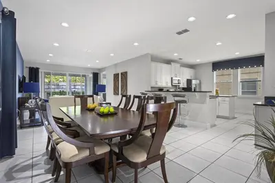 a kitchen and dining room with a table and chairs at 350-360 Huge Villas - near Disney - 15 BDs in Orlando