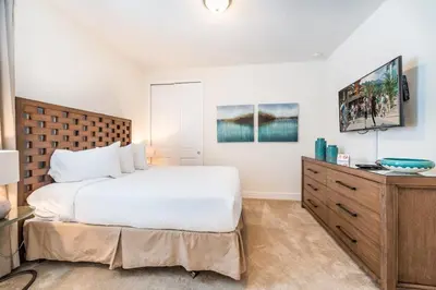 a bedroom with a large bed and a dresser at 350-360 Huge Villas - near Disney - 15 BDs in Orlando