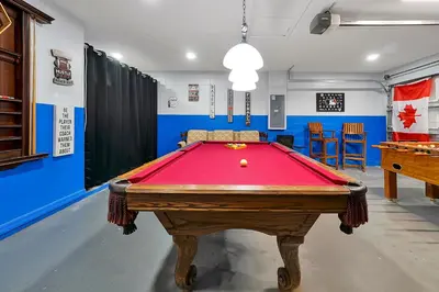 a ping pong table in a room with a pool table at Walkin' on Sunshine - 5 bed pool home in Terra Verde Resort near Disney in Kissimmee
