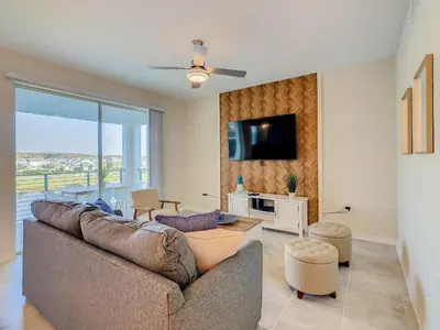 a living room with a couch and a tv at Gorgeous 2BR lakeview Condo with Waterpark in Kissimmee