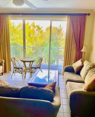 a living room with a couch and a table at Disney 1 mile , Blue Heron 1 room 2 bath,amenities,6 guests, walk to restaurants, no fees at check in in Orlando