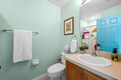 a bathroom with a white toilet and a sink at Near Disney, Recently Renovated, Clubhouse in Kissimmee