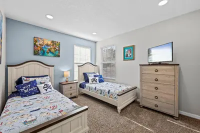 a bedroom with two beds and a tv and a dresser at Near Disney, Recently Renovated, Clubhouse in Kissimmee