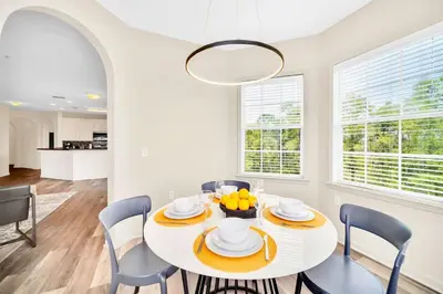 a white dining room with a white table and chairs at Upstay - Pet-Friendly Suite w Pool, Sauna in Orlando