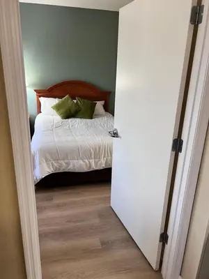 a bedroom with a bed and a door leading into a room at Great Condo Incredible Location in Orlando