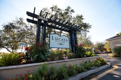 a sign for a library with a sign in a garden at 5366 Unit 17-106 Lovely home inside Disney area in Kissimmee
