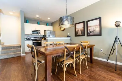 a dining room and kitchen with a wooden table and chairs at 5366 Unit 17-106 Lovely home inside Disney area in Kissimmee