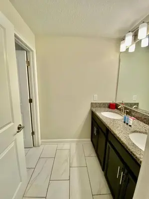 a bathroom with two sinks and a mirror at Excellent Resort Free/ Makin Memories / 4 Beds in Kissimmee